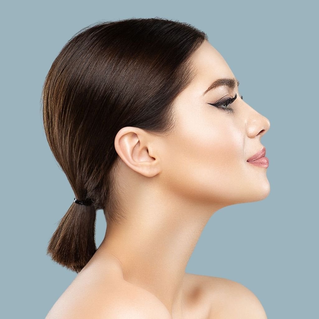 Side profile view highlighting sharp jawline definition and submental smoothness, ideal for Fotona intra-oral tightening by expert dermatologists at Transform Head to Toe